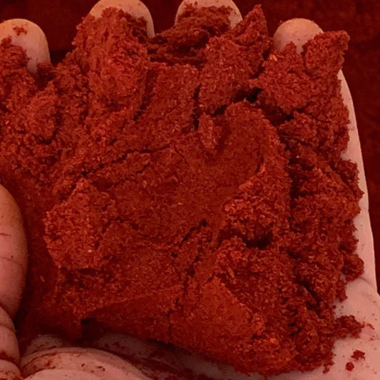 hand holding red powder