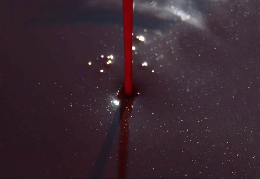 Liquid robin red being poured into a bowl 