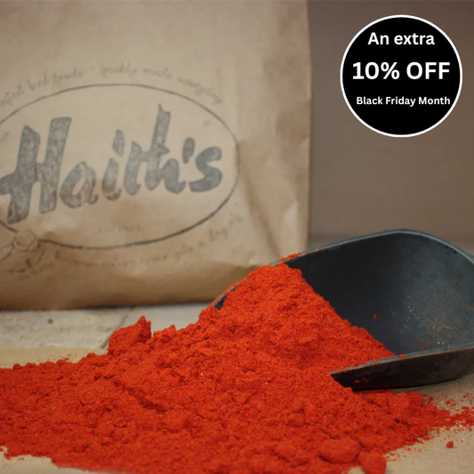 A scoop of Robin Red with a bag in the background bearing the 'Haith's' brand logo.